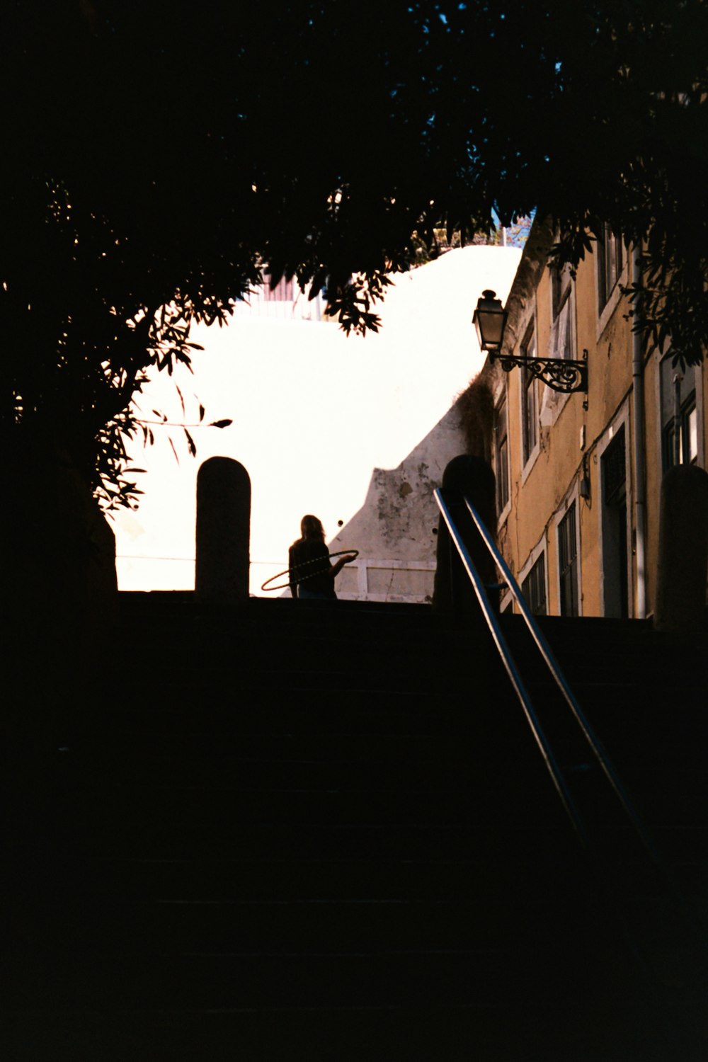 a couple of people sitting on top of a set of stairs