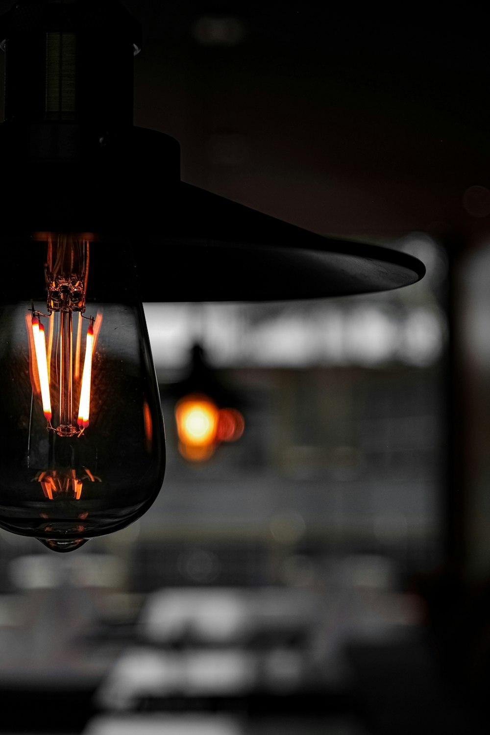 a light bulb hanging from a ceiling in a dark room