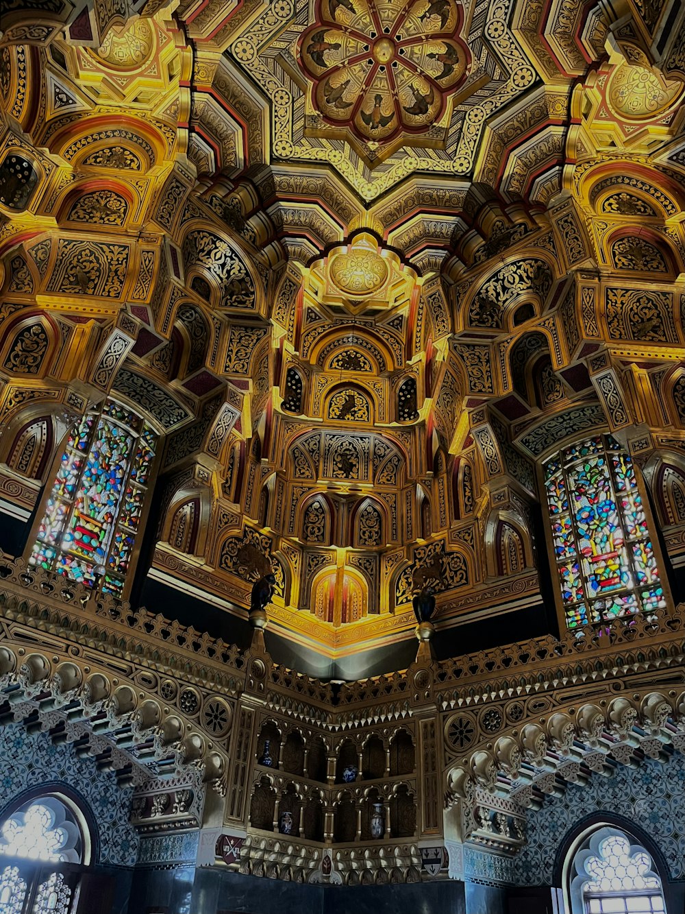 the ceiling of a church with stained glass windows