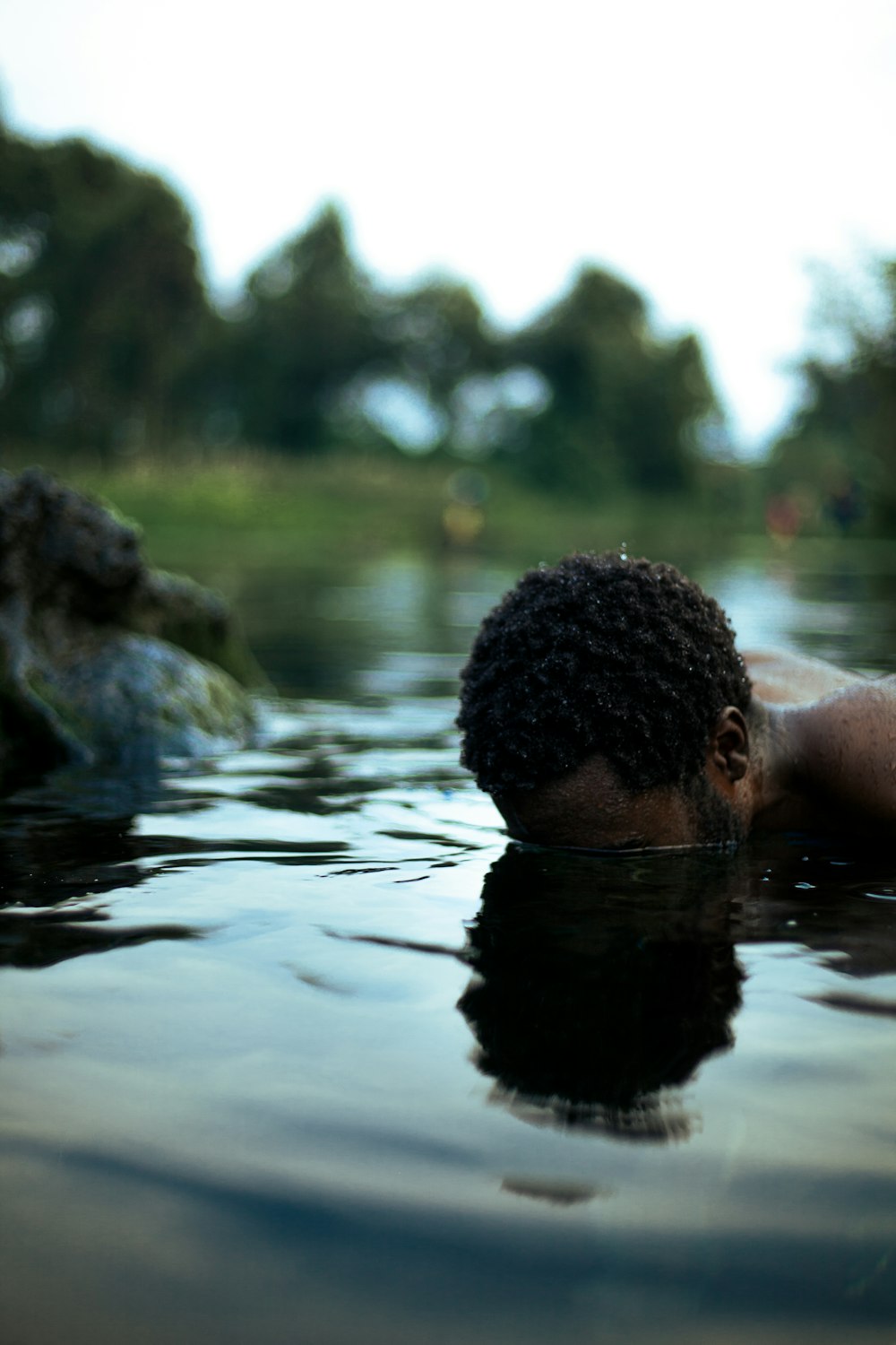 a man swimming in a body of water