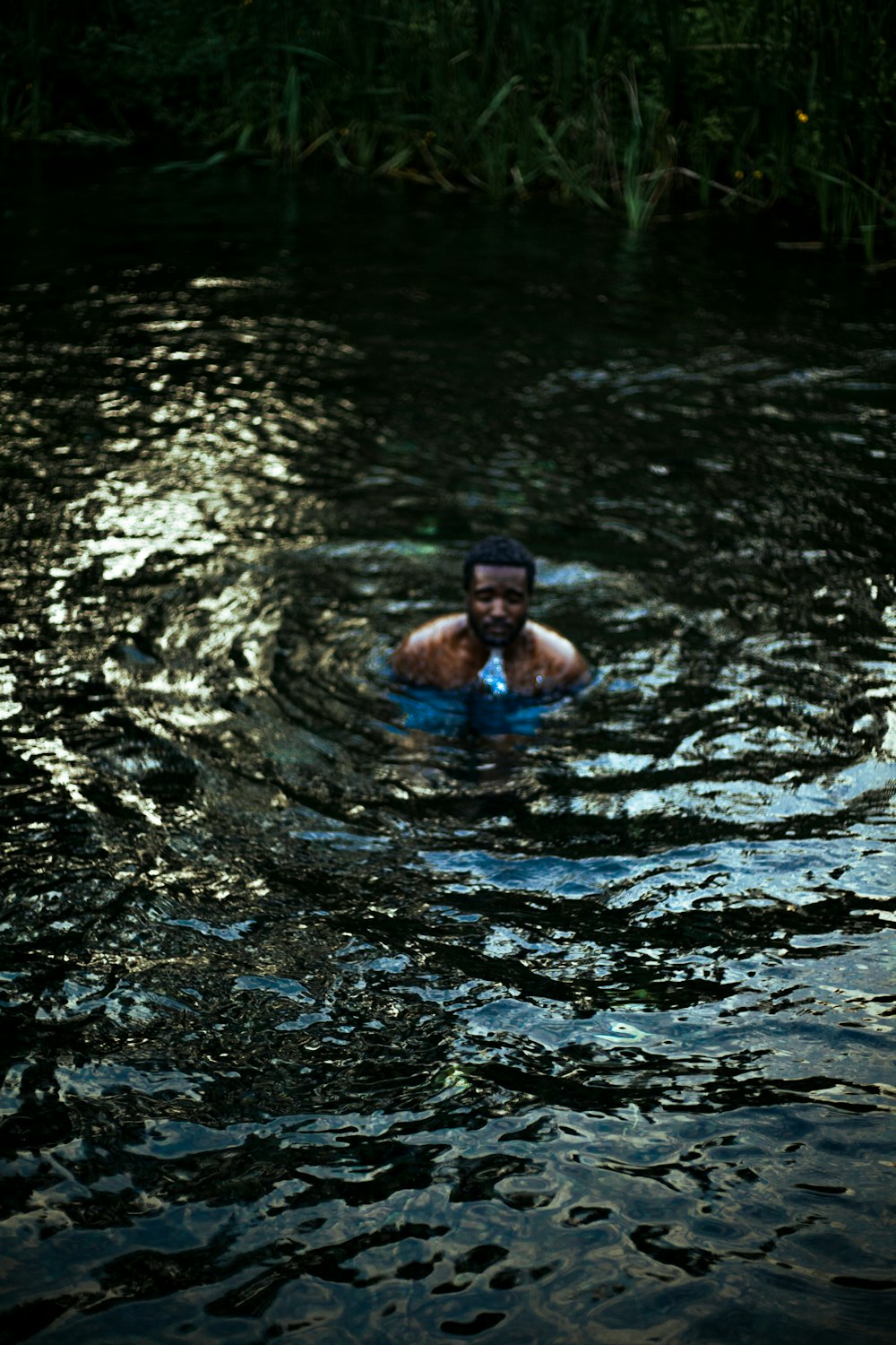 a man swimming in a body of water