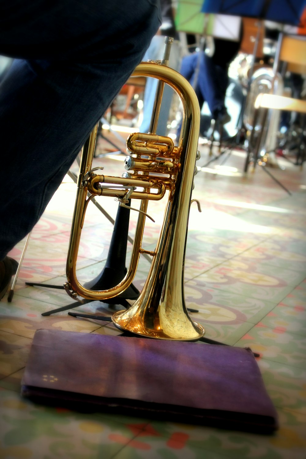 a brass trumpet sitting on top of a wooden stand