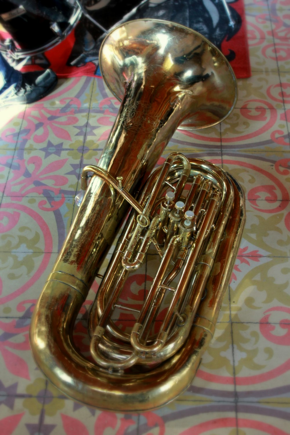 a close up of a trumpet on a tiled floor