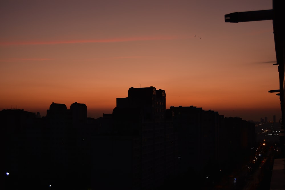 a view of a city at sunset from a high rise building