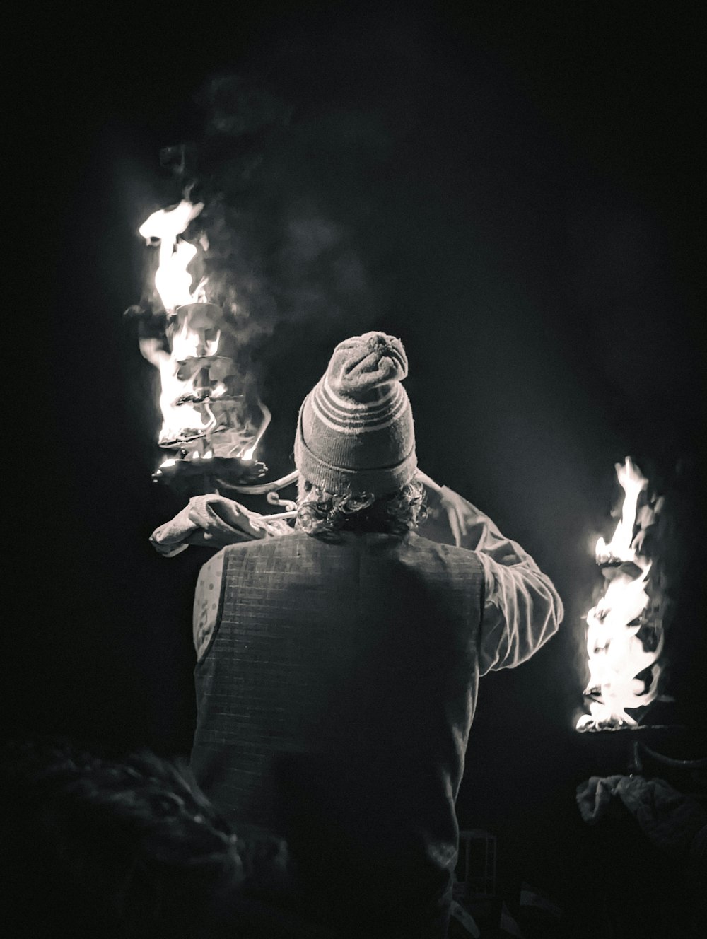 a man standing in the dark holding a plate of food