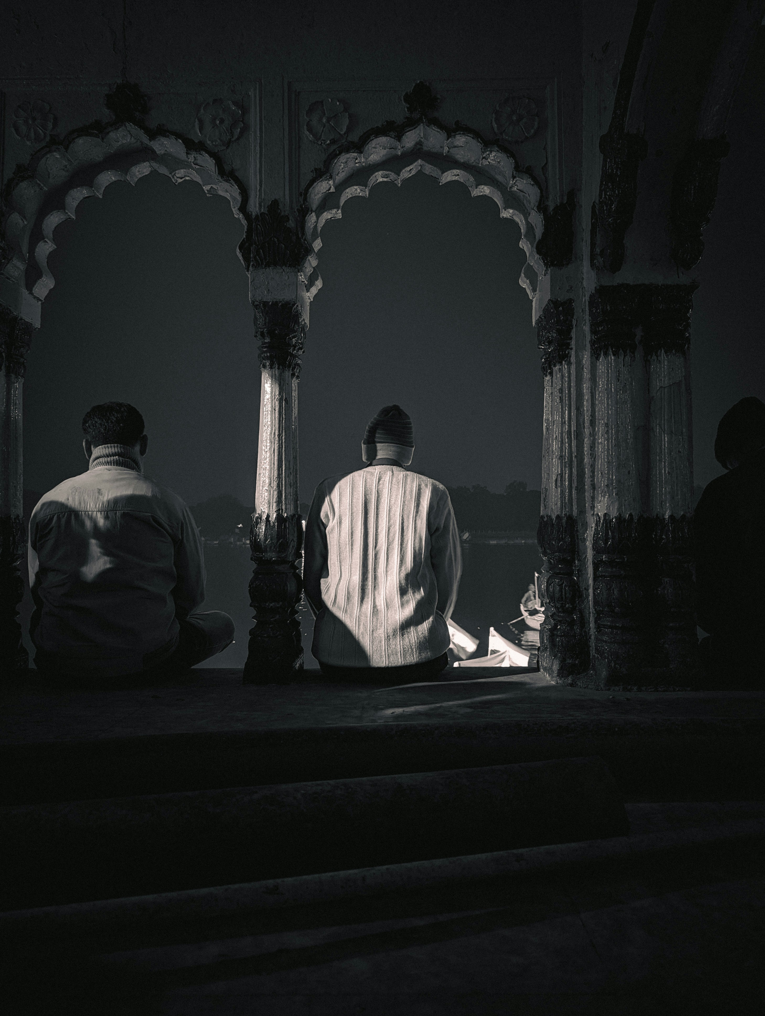 a couple of men sitting next to each other