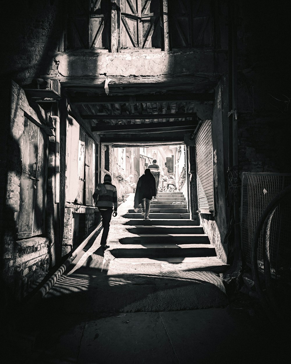 two people walking down a dark alley way