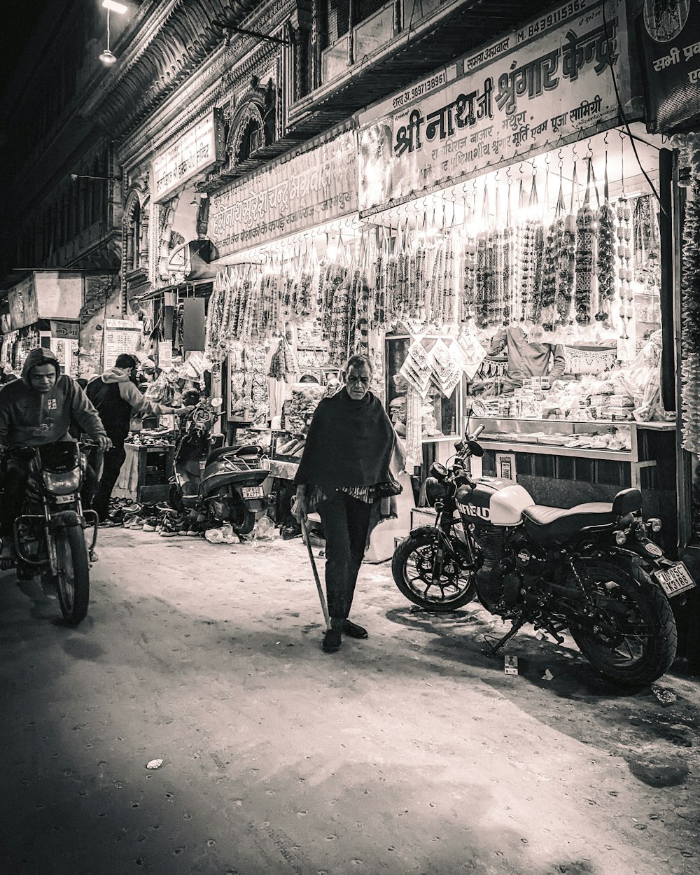 a man walking down a street next to a motorcycle