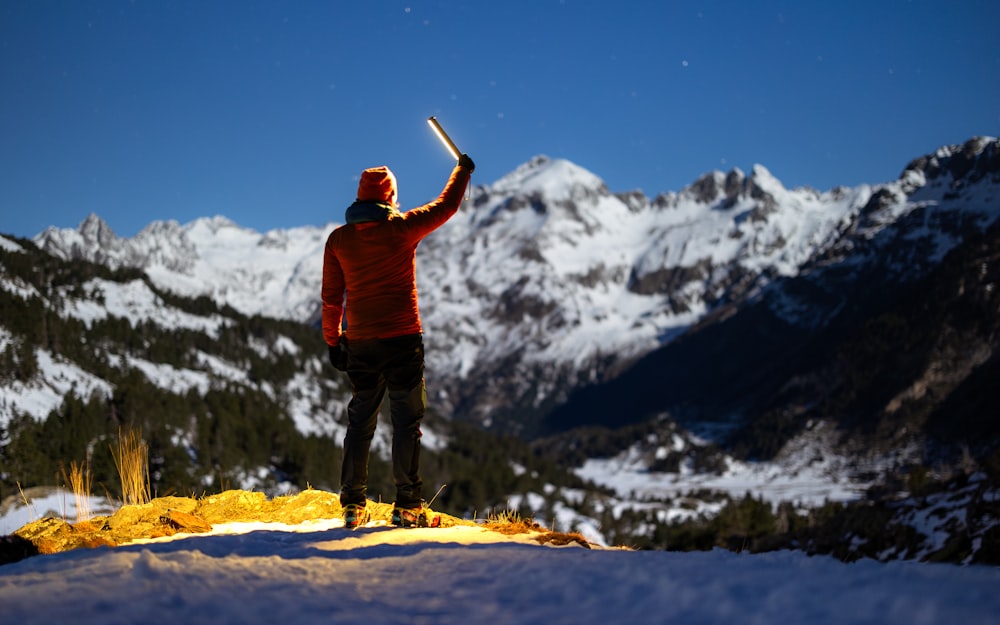 a person standing on top of a snow covered mountain