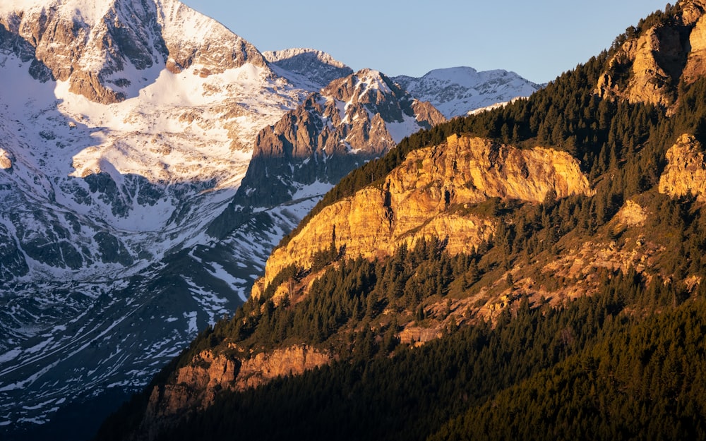 a mountain range with snow covered mountains in the background