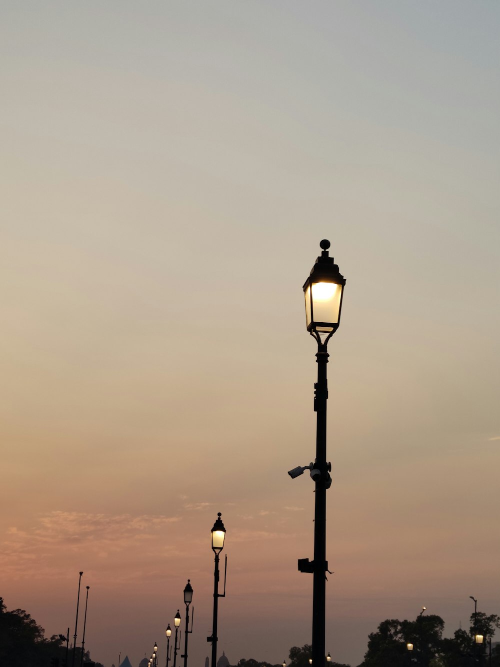 a street light sitting next to a lamp post