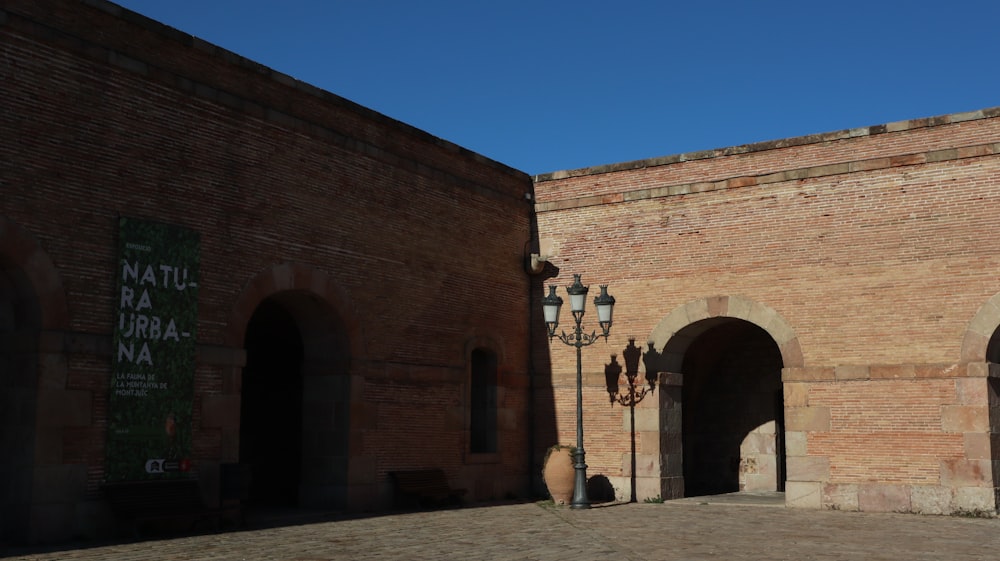 a brick building with a lamp post in front of it