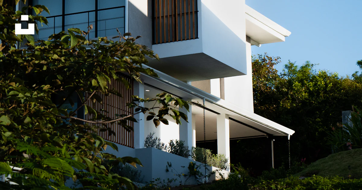 A white building with a lot of windows on it photo – Free Costa rica ...