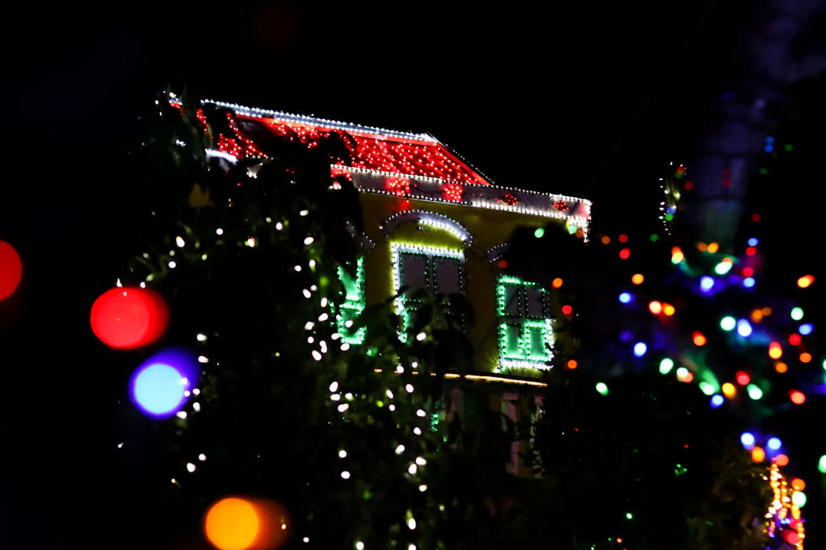 Home exterior with Christmas lights glowing at night