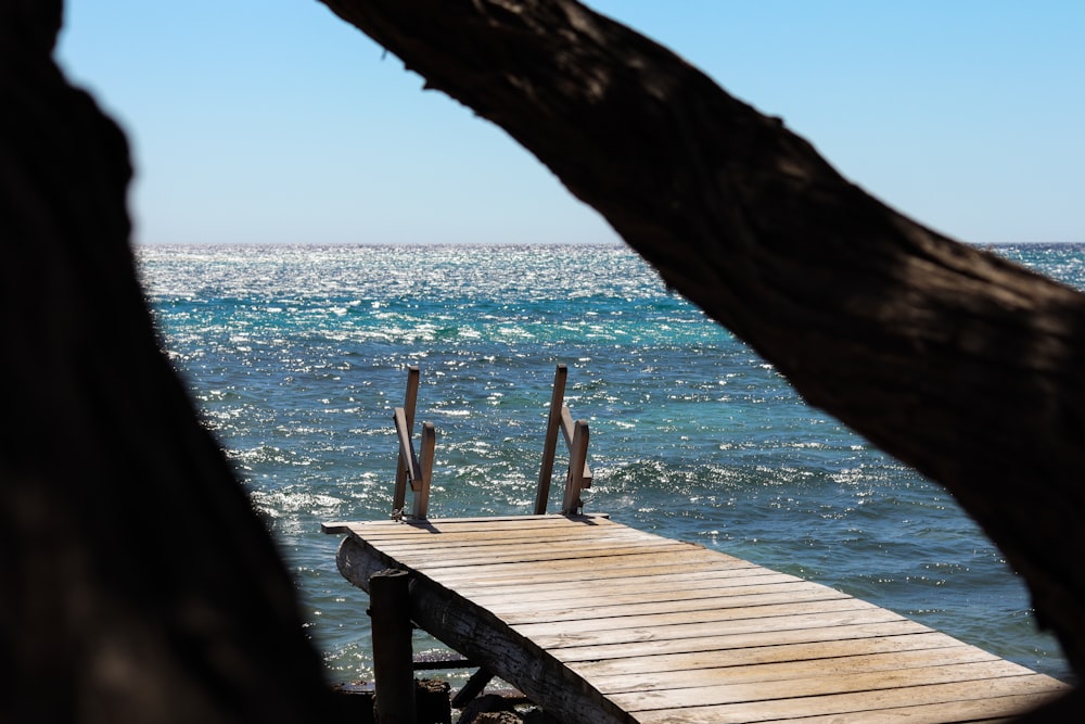 a wooden dock sitting on top of a body of water