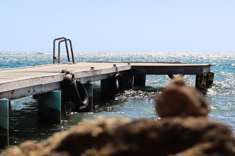 a boat is docked at the end of a pier