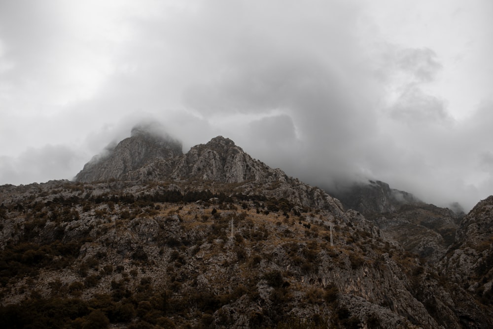 a very tall mountain with some clouds in the sky