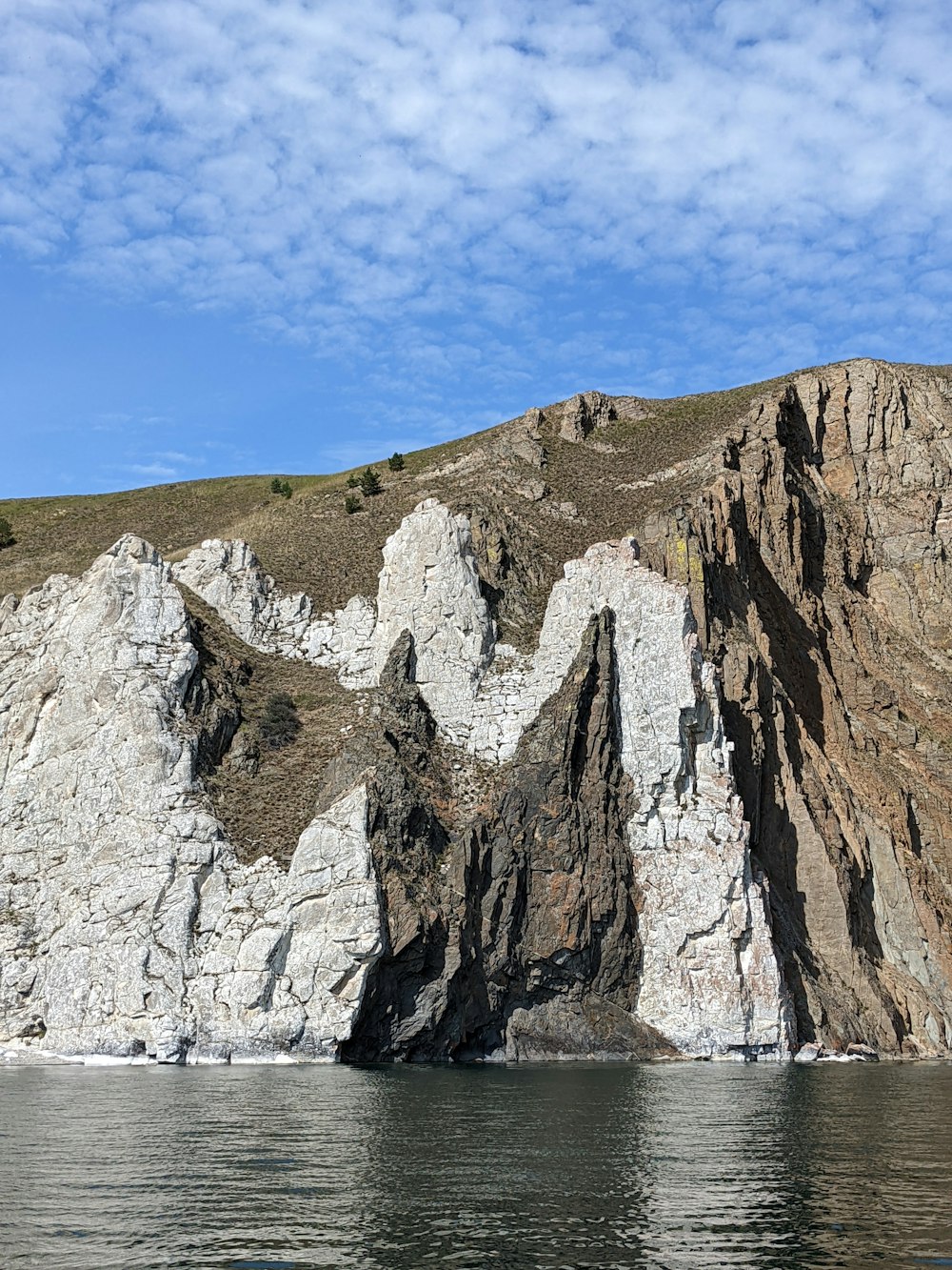 a large rock formation in the middle of a body of water