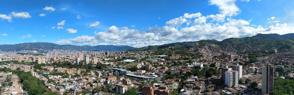 a panoramic view of a city with mountains in the background