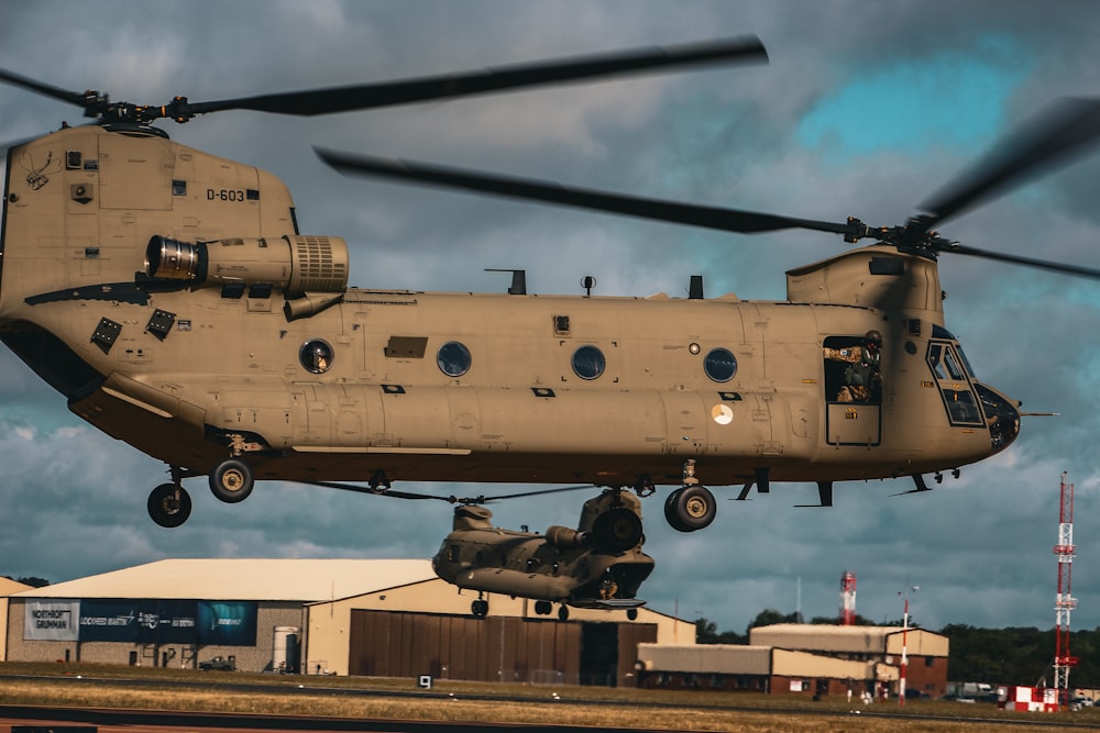 a large military helicopter taking off from a runway