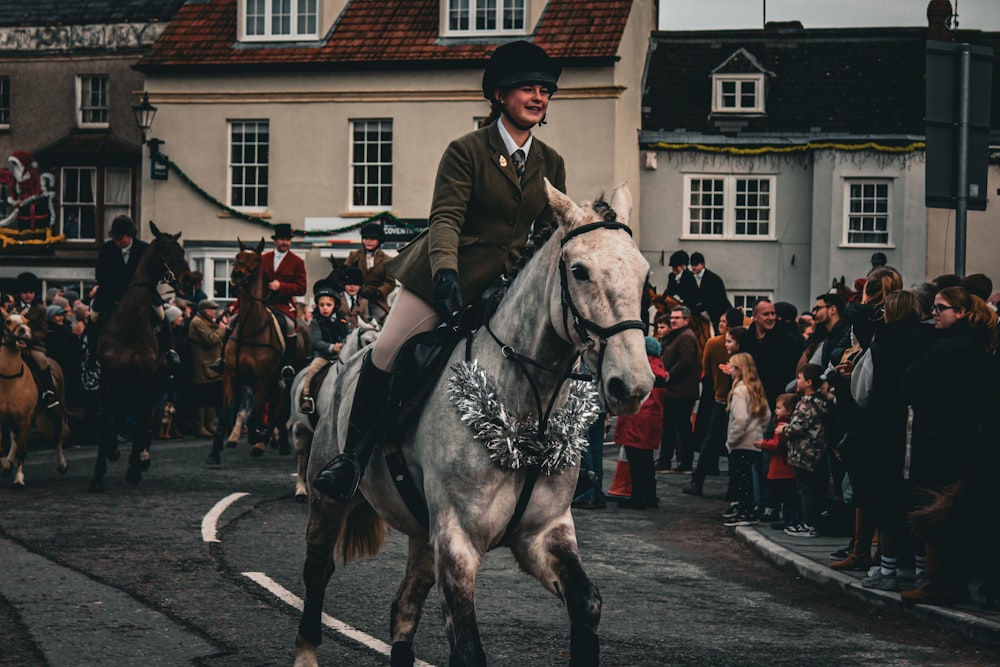 a man riding on the back of a white horse