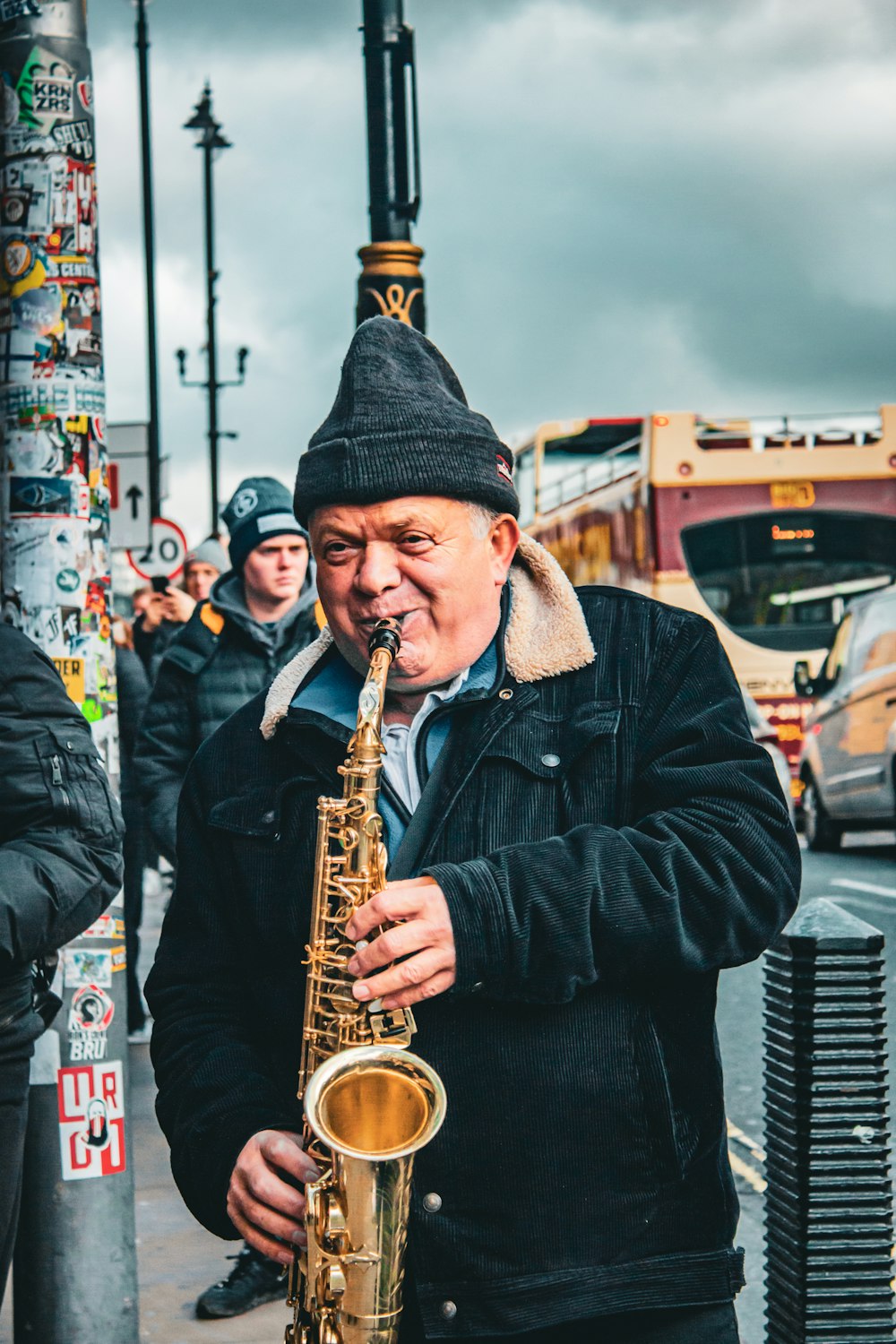 a man playing a saxophone on a city street