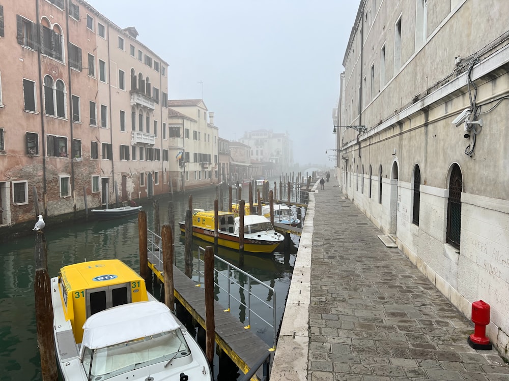 a boat is docked in a canal in a city