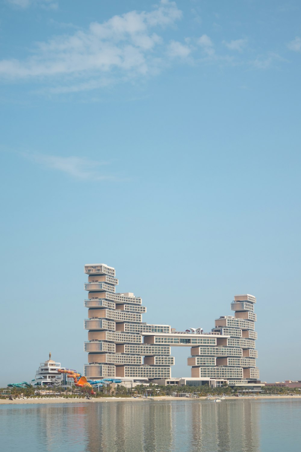 a tall building sitting on top of a body of water