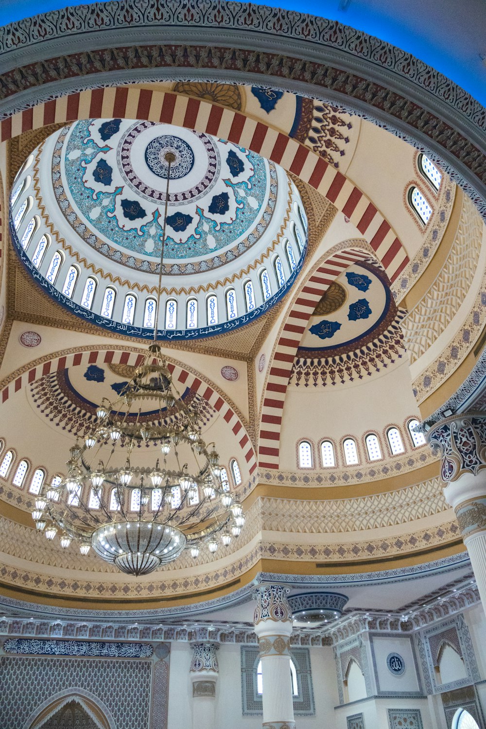 a domed ceiling with chandeliers and a chandelier hanging from the ceiling