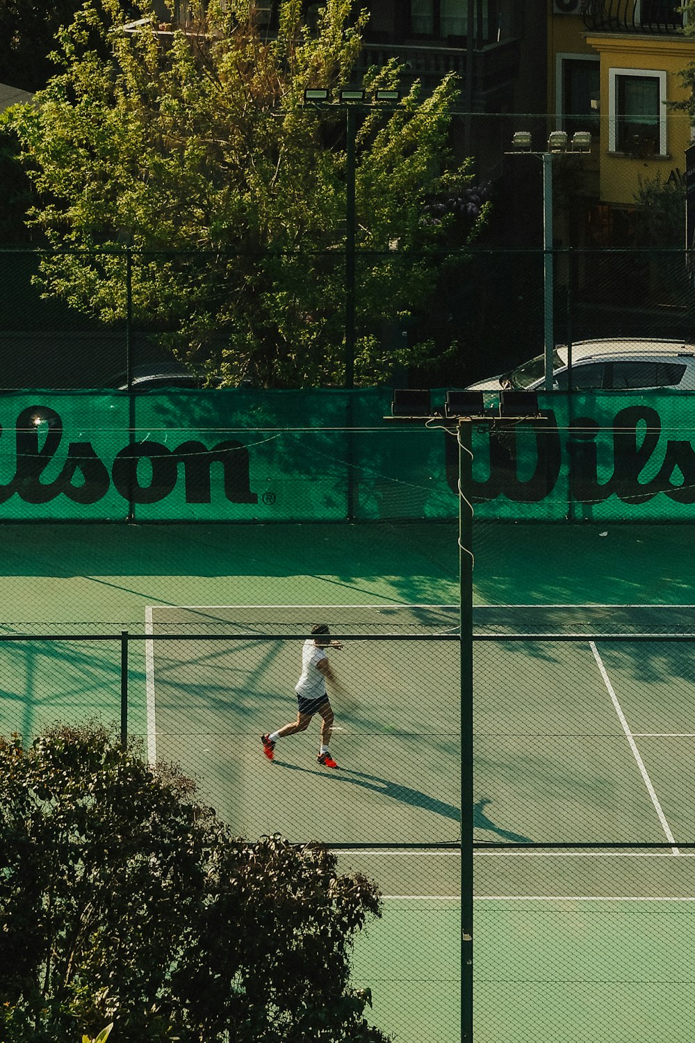 a man on a tennis court holding a racquet