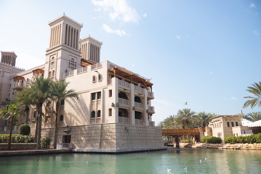 a large white building sitting next to a body of water