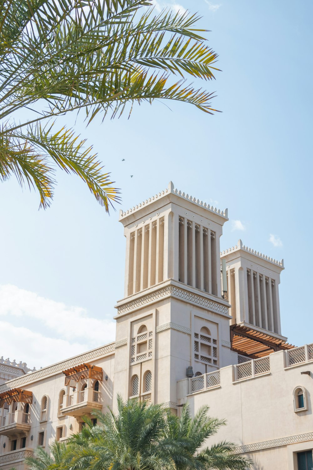 a tall white building with a clock on it's side