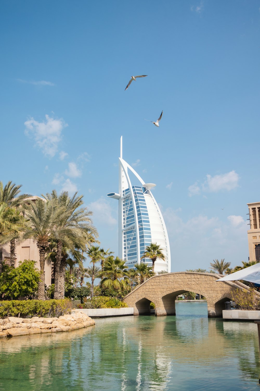 a bridge over a body of water with a building in the background