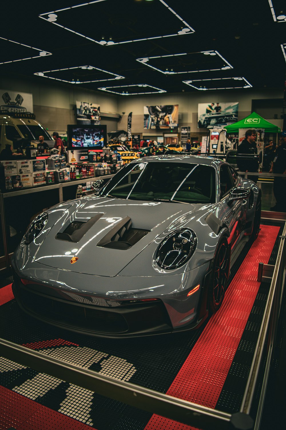 a silver sports car on display in a showroom