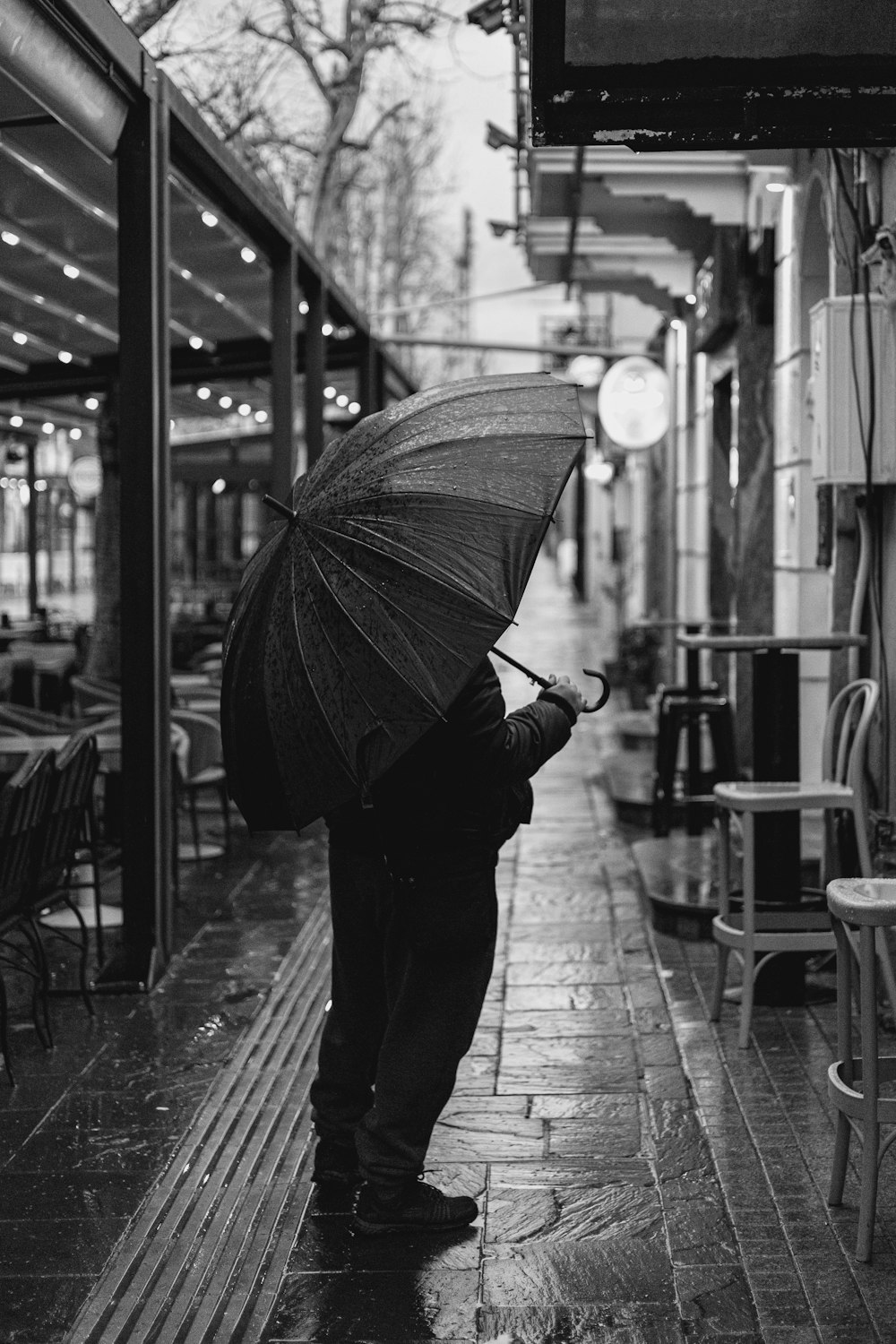 a man holding an umbrella on a rainy day