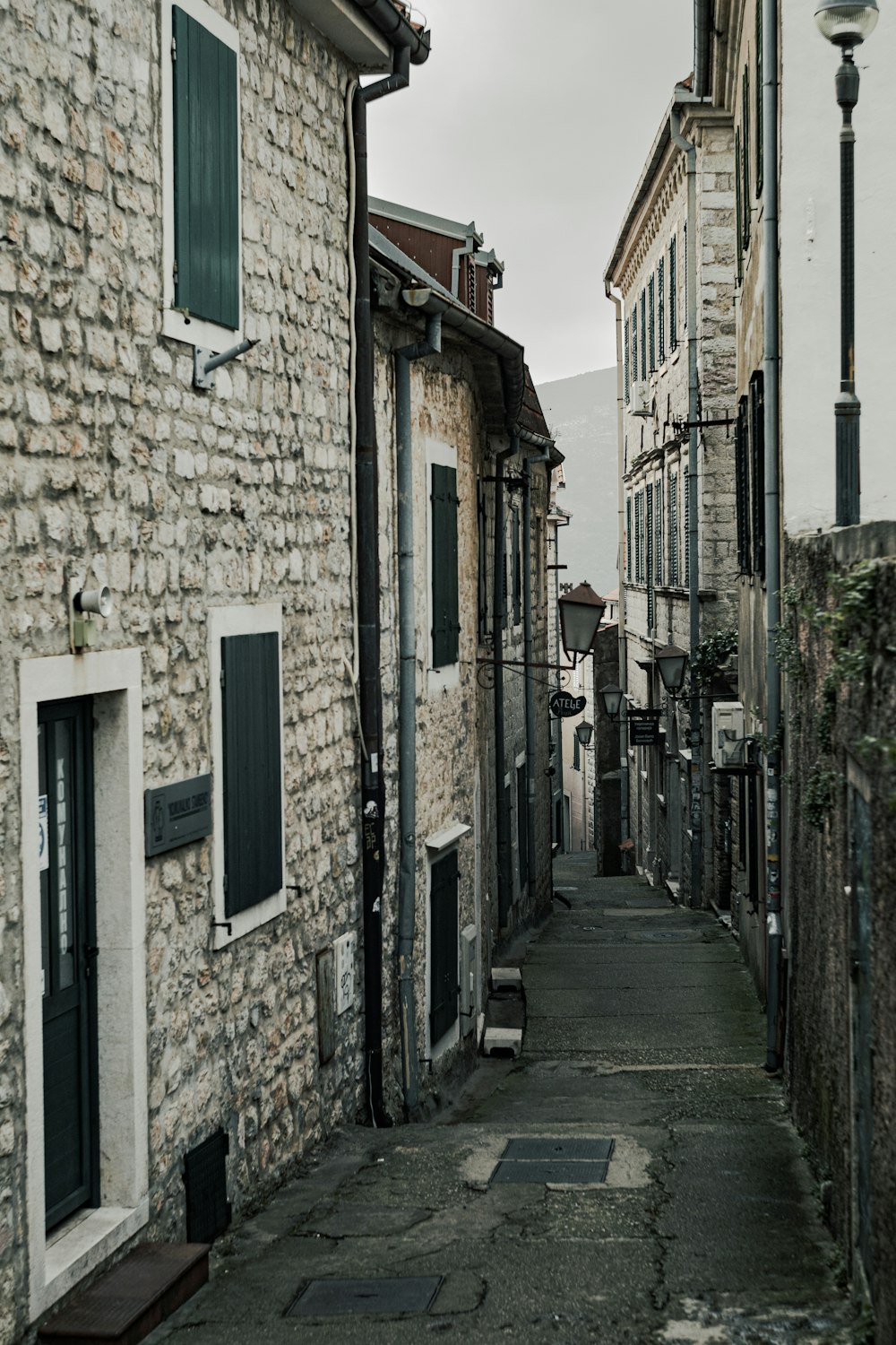 a narrow street with stone buildings on both sides