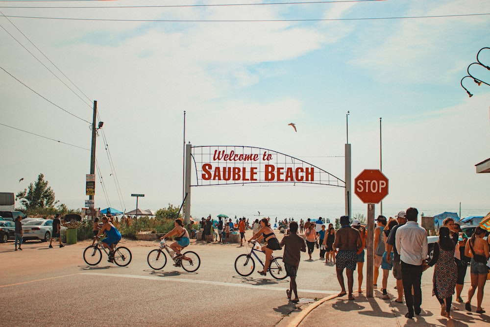 a group of people riding bikes down a street