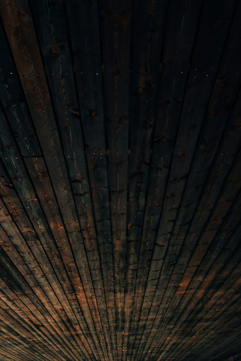 a man riding a surfboard on top of a wooden pier