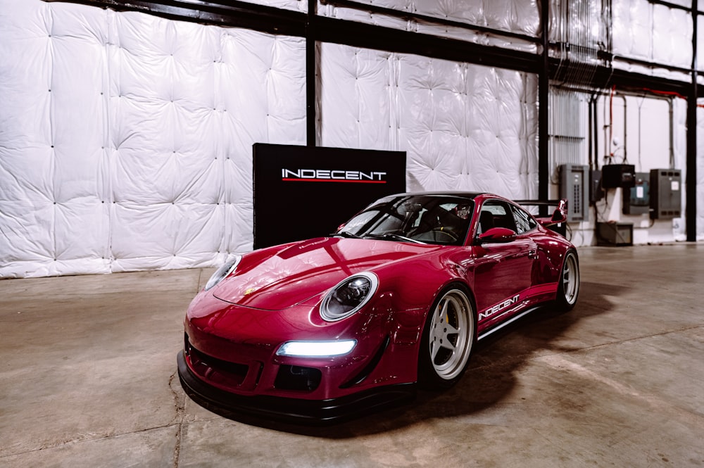 a red sports car parked in a garage