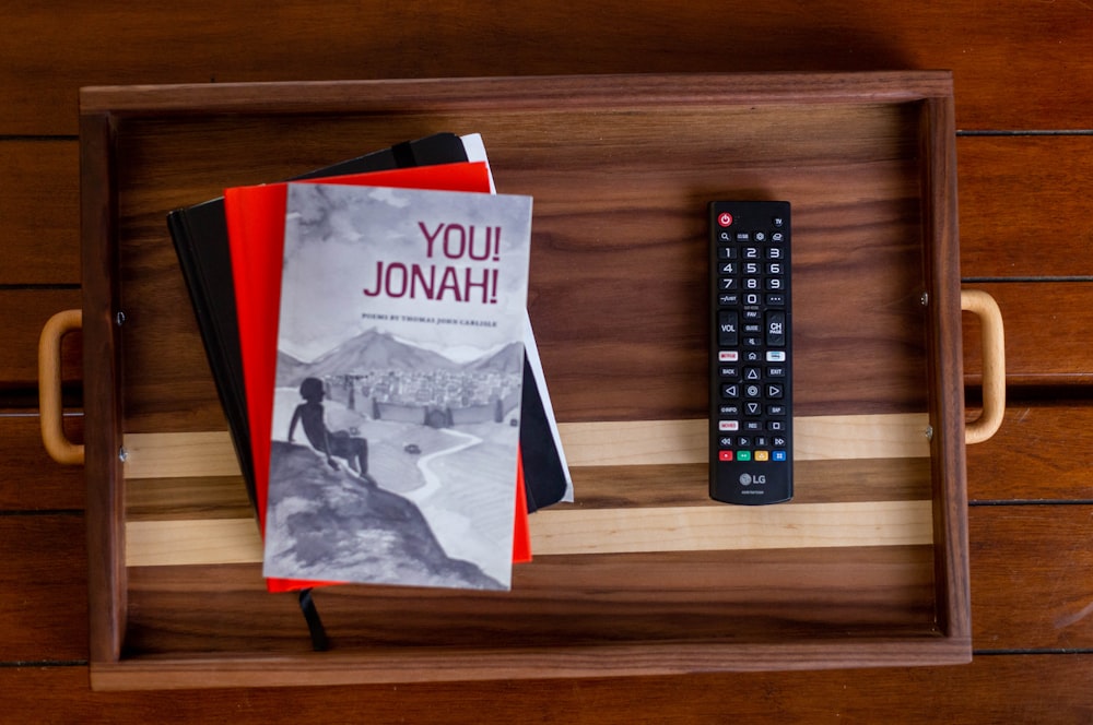 a remote control sitting on top of a wooden tray