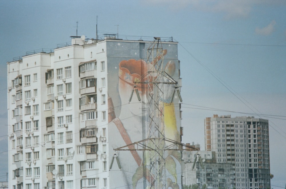 a tall building with a mural on the side of it