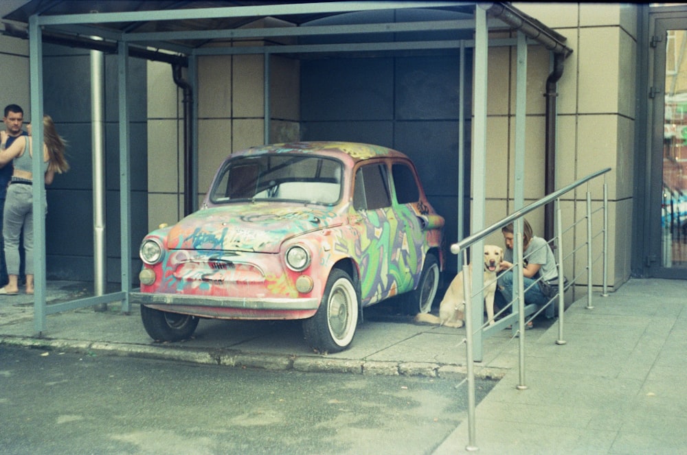 a colorful car parked in front of a building