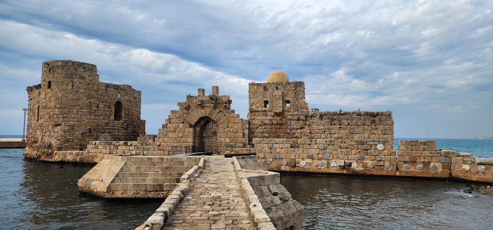 a stone castle sitting on top of a body of water