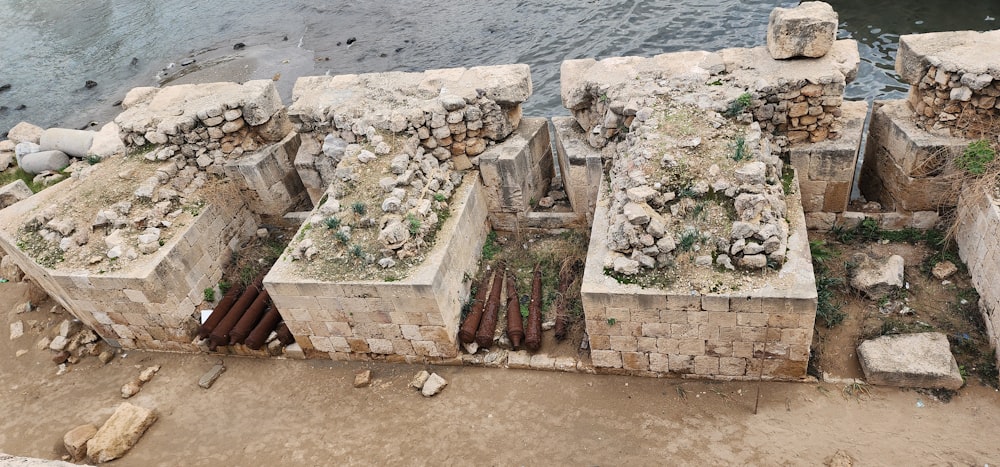 a group of cement blocks sitting next to a body of water