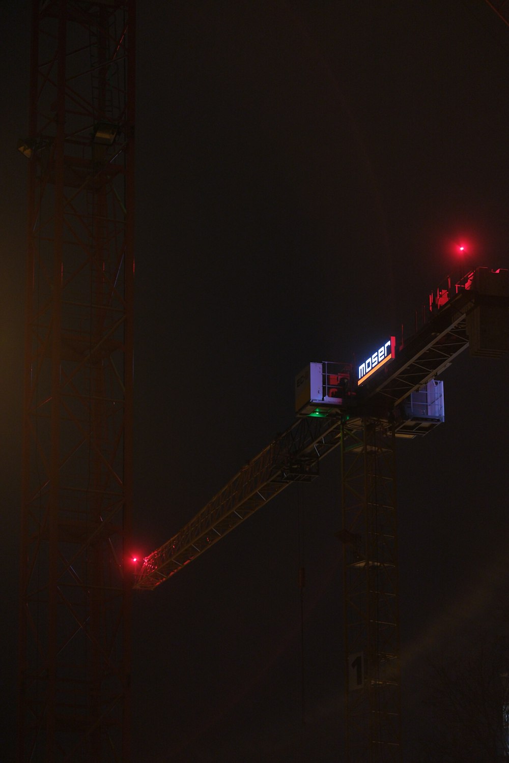 a red traffic light sitting on top of a crane