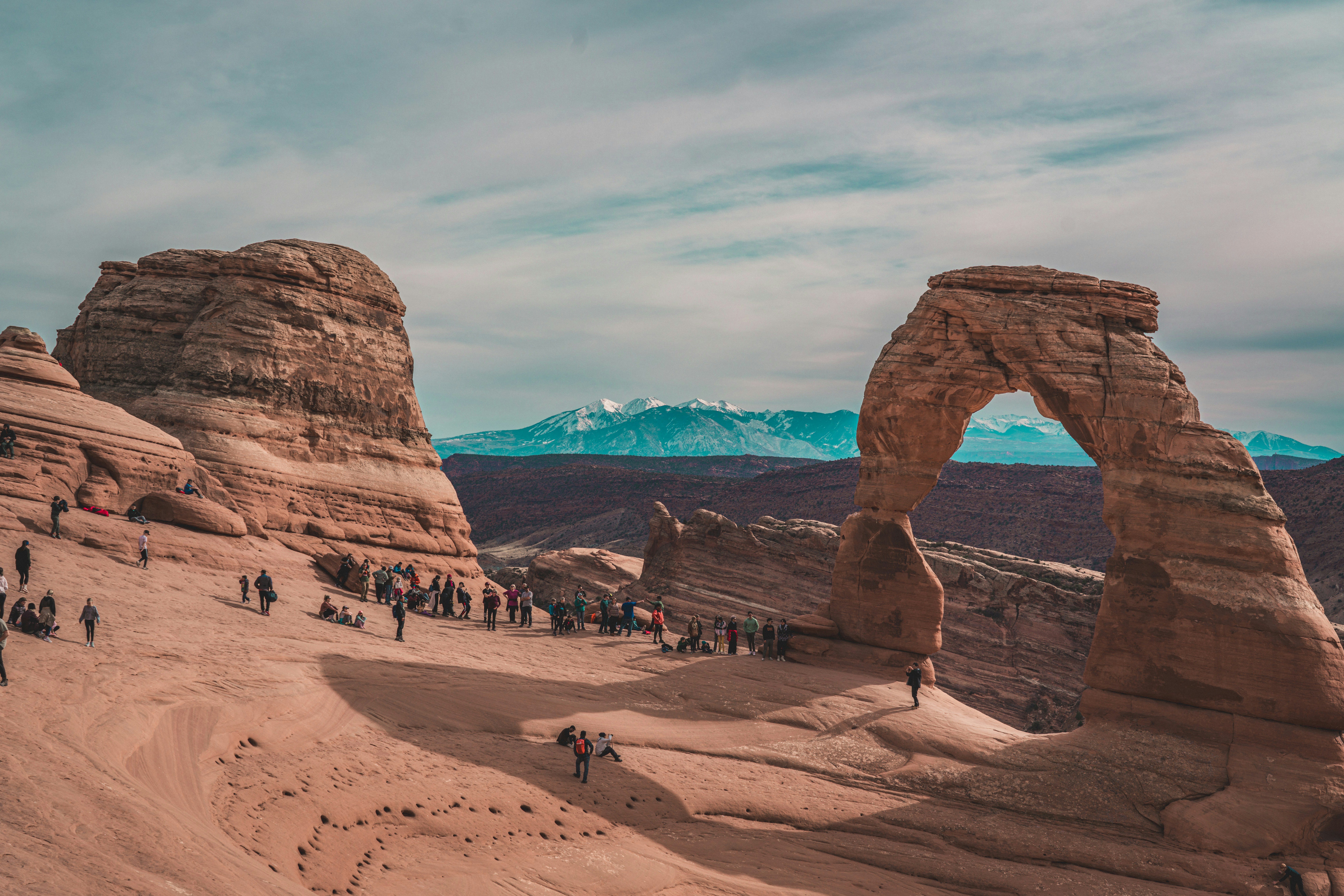 a group of people standing on top of a desert