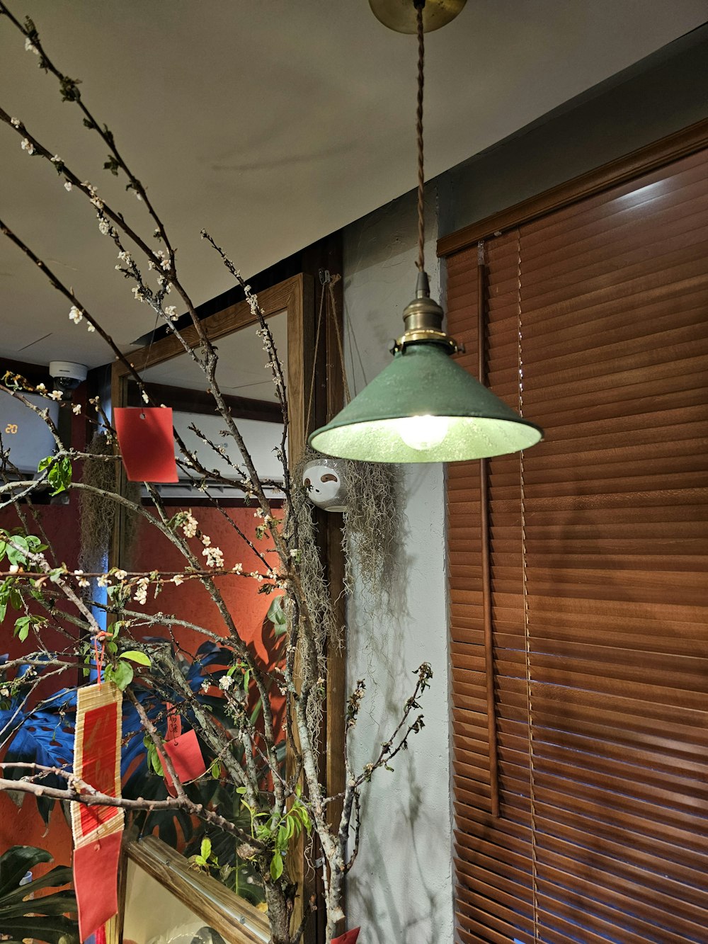 a lamp hanging from a ceiling next to a window