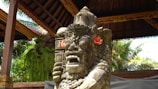 a statue of a man with a flower in his hair
