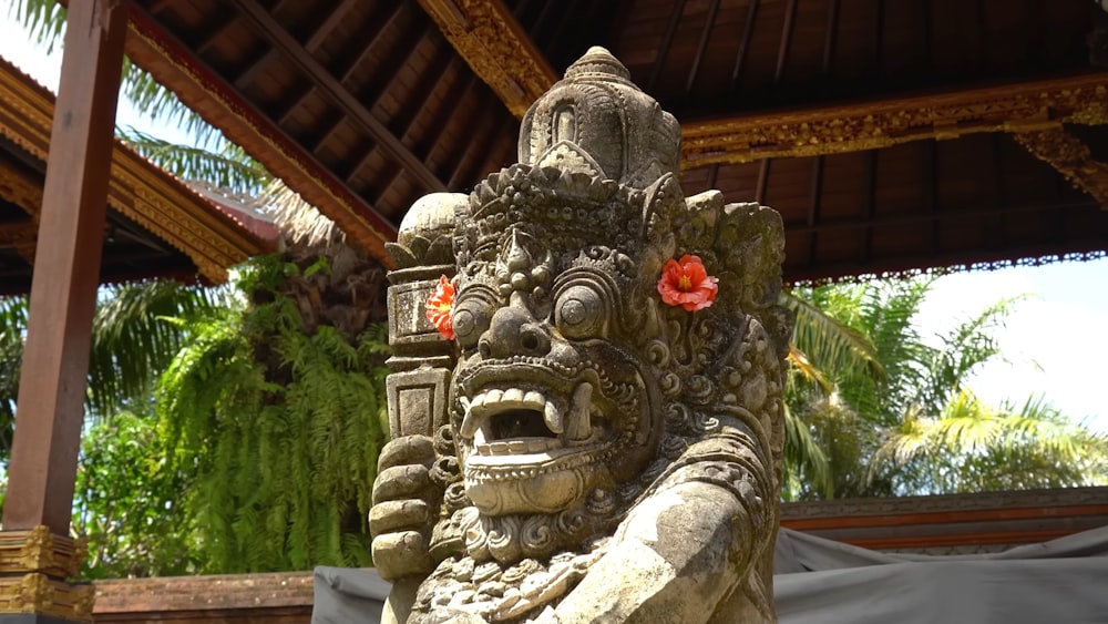 a statue of a man with a flower in his hair