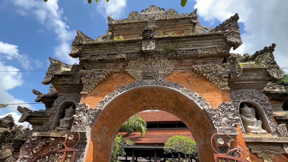 a stone archway with statues on top of it